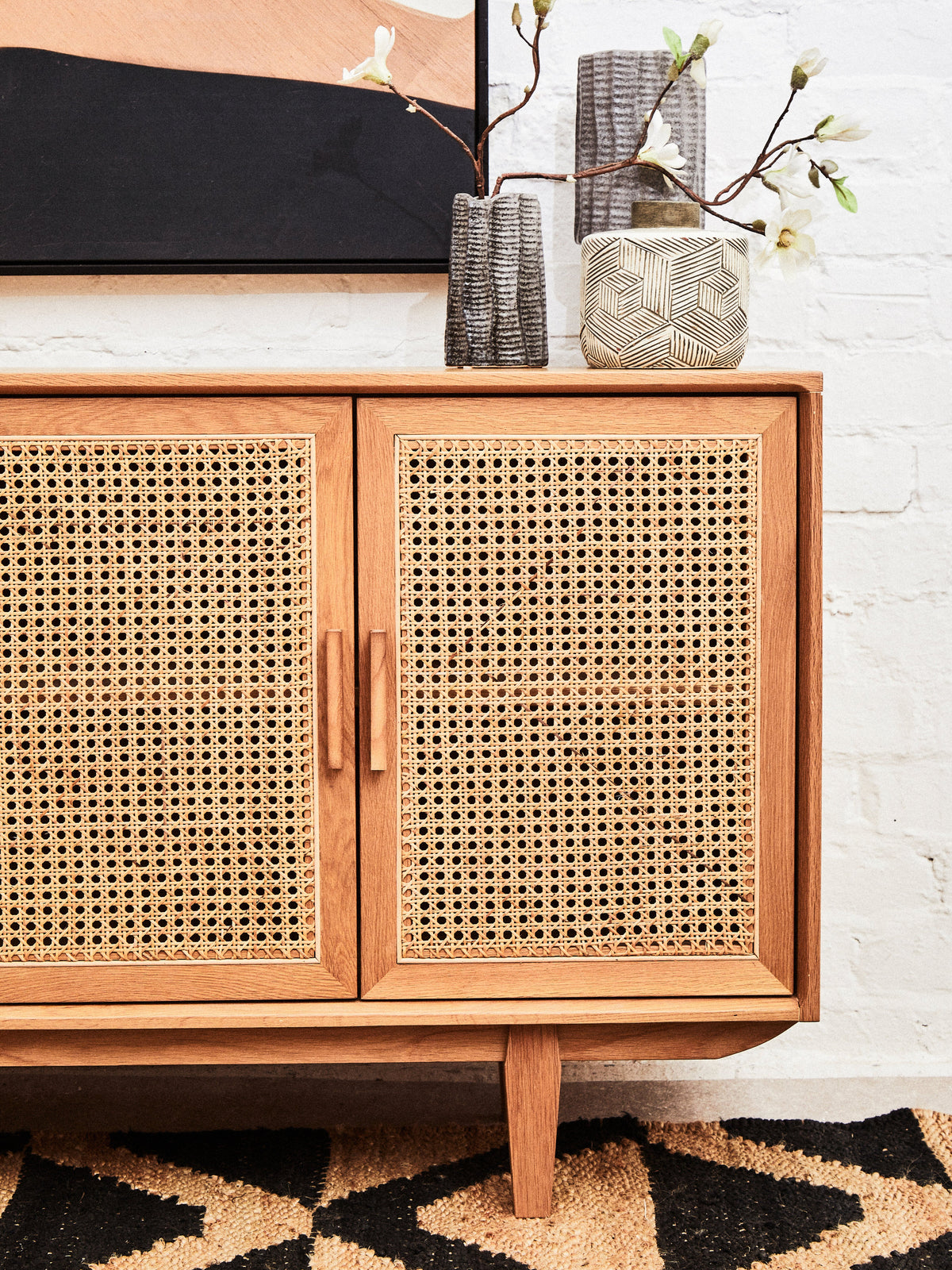 Wooden cabinet with wicker doors in a room setting