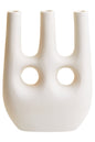 White vase with three cylindrical sections and circular openings on a white background