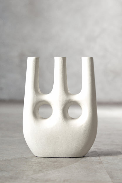 White abstract vase on a gray surface with a neutral background