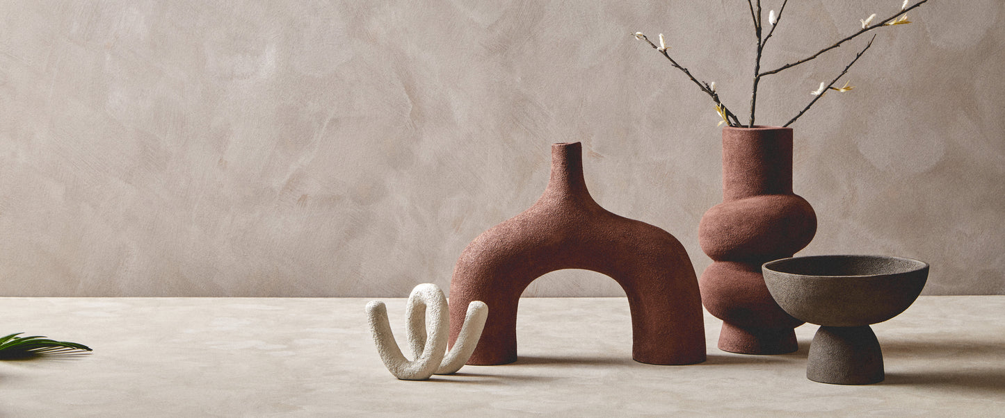 Collection of unique ceramic pieces on a neutral background