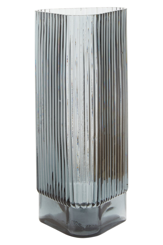 Tall, ribbed glass vase on a white background
