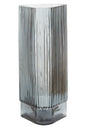 Tall, ribbed glass vase on a white background