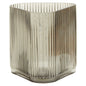 Glass vase with ribbed design on a white background