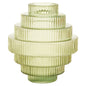 Green glass vase with ribbed texture on a white background