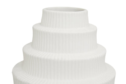 White ceramic vase with ribbed texture on a white background