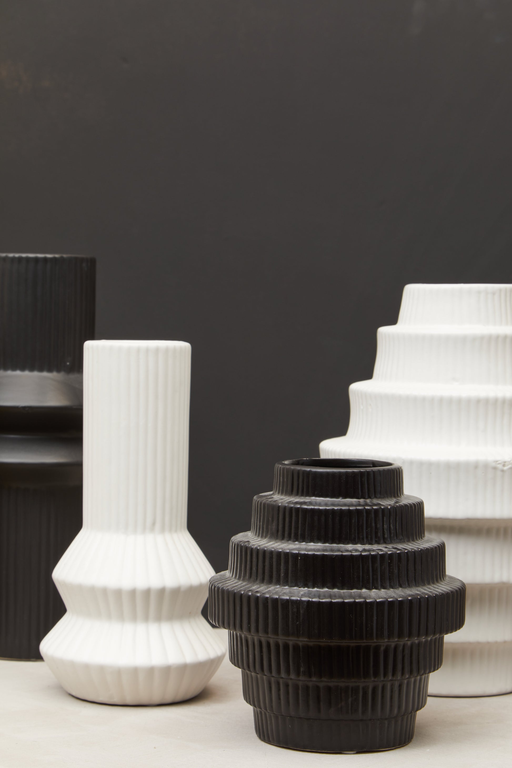 Black and white textured vases on a dark background