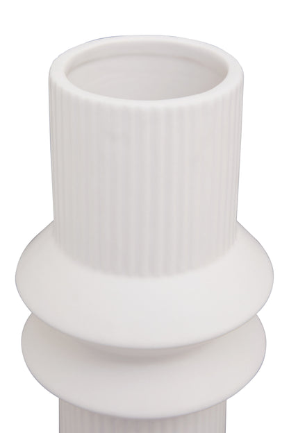 White ceramic vase with ribbed design on a white background