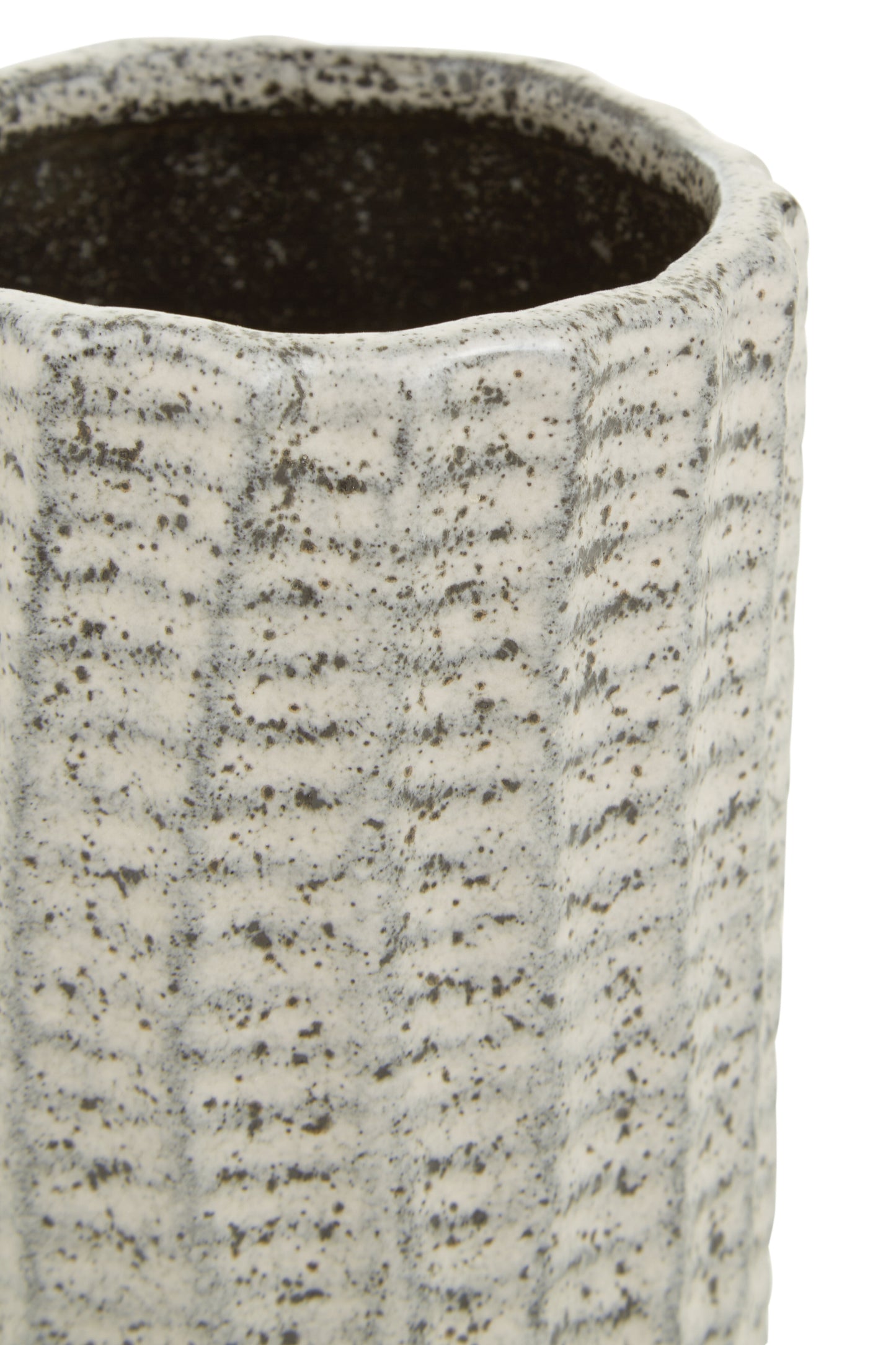 Close-up of a textured ceramic vase with a ribbed surface.