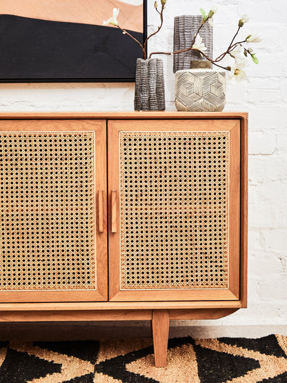 Wooden cabinet with wicker doors in a room setting