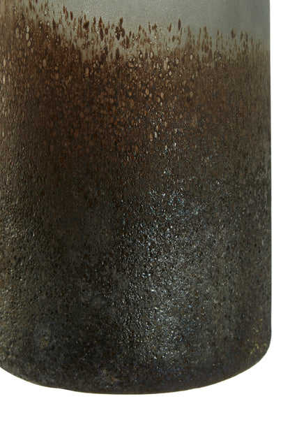 Close-up of a cylindrical ceramic vase with a textured surface and gradient color from brown to black.