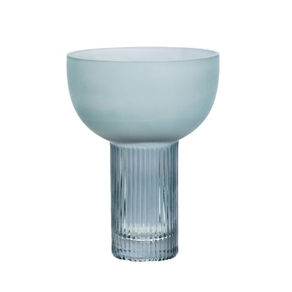 Blue glass vase with ribbed design on a white background