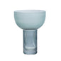 Blue glass vase with ribbed design on a white background