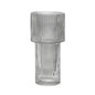Clear glass vase with ribbed texture on a white background