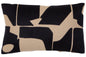 Decorative pillow with black and beige abstract pattern on a plain background